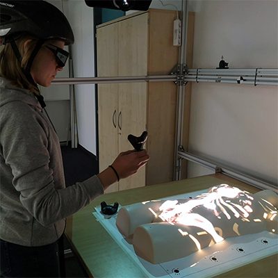 Clutch & Grasp: Activation gestures and grip styles for device-based interaction in medical spatial augmented reality